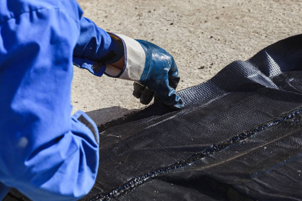 istock The worker puts waterproofing on the concrete surface. 922765142