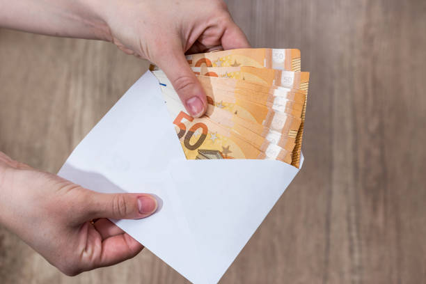 istock female withdrawing euro money from an envelope 922765156