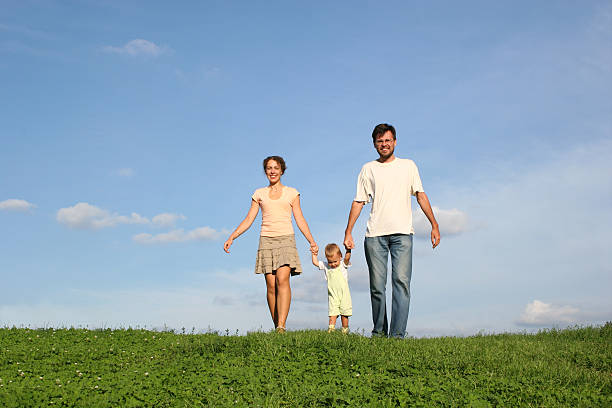 istock family with baby walking on grass 92276566