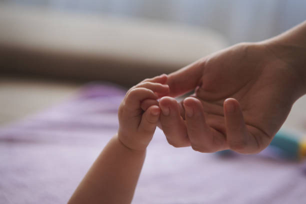 istock Mother and baby hands closeup 922769106