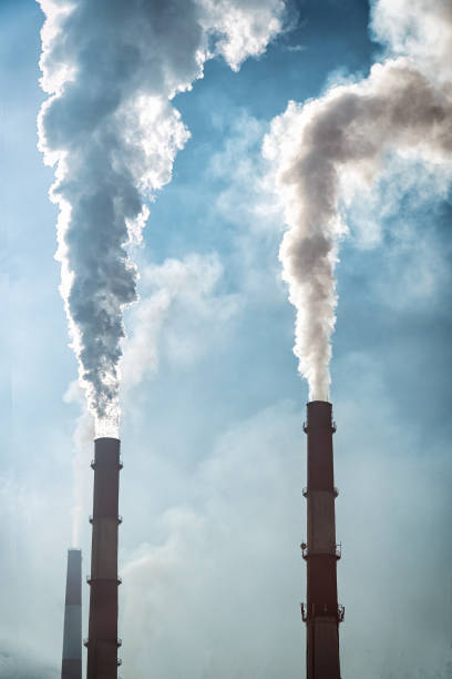 istock Smoke from factory pipes against blue sky 922769156