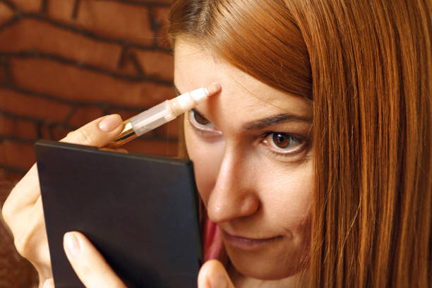istock A young girl hides skin imperfections using a cosmetic corrector 922769654