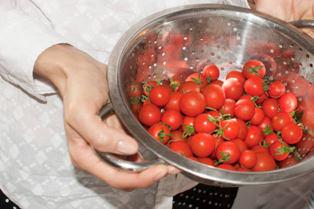 istock A woman holding a plate with cherry tomatoes 922769850