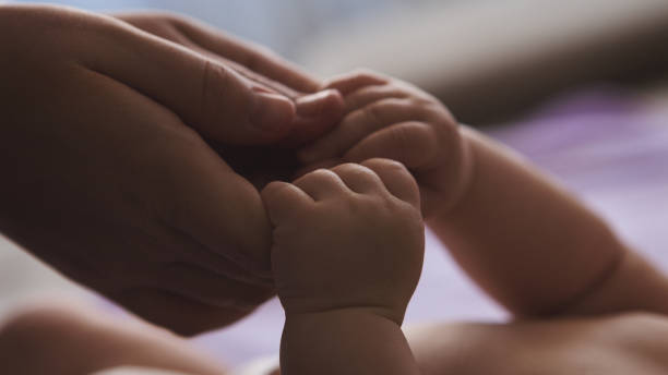 istock Mother and baby hands closeup 922770034