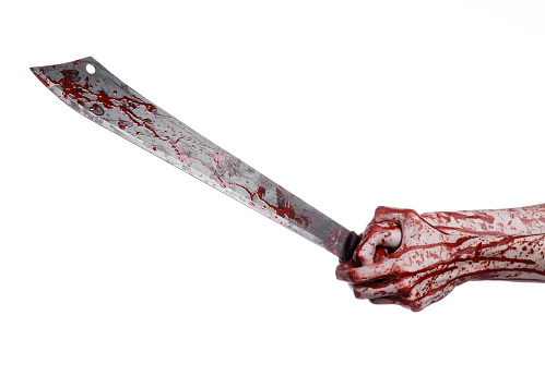 Halloween theme: hand holding a bloody machete on a white background