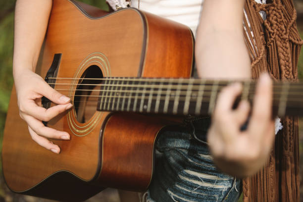 istock Young Asian Hipster playing guitar in the park 922770144