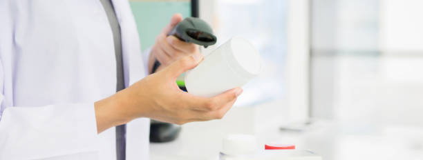 istock Pharmacist scanning medicine bottle with barcode scanner in drugstore 922770518