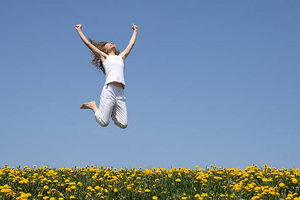 istock Smiling young woman in a happy jump 92277078