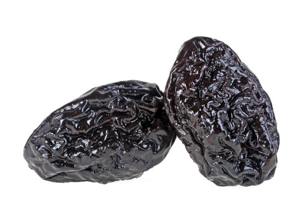 istock Smoked prunes isolated on a white background, close-up 922770902