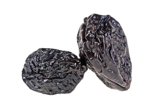 istock Smoked prunes isolated on a white background, close-up 922770914
