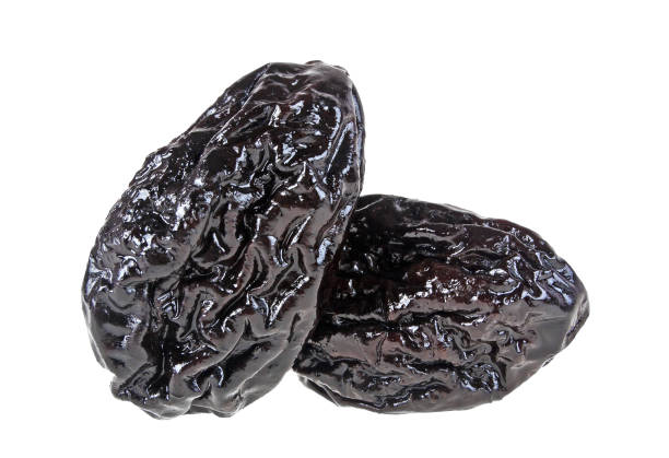 istock Smoked prunes isolated on a white background, close-up 922770940