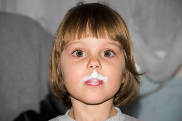 Child Eating Yoghurt With Very Expressif Face