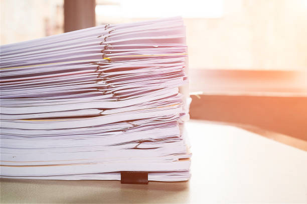 istock Pile of unfinished documents on office desk, Stack of business paper 922771336