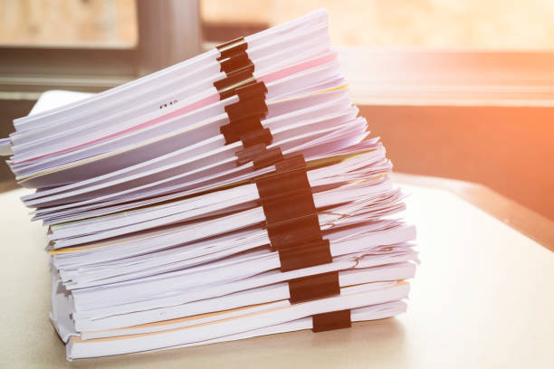 istock Pile of unfinished documents on office desk, Stack of business paper 922771338