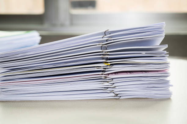 istock Pile of unfinished documents on office desk, Stack of business paper 922771342