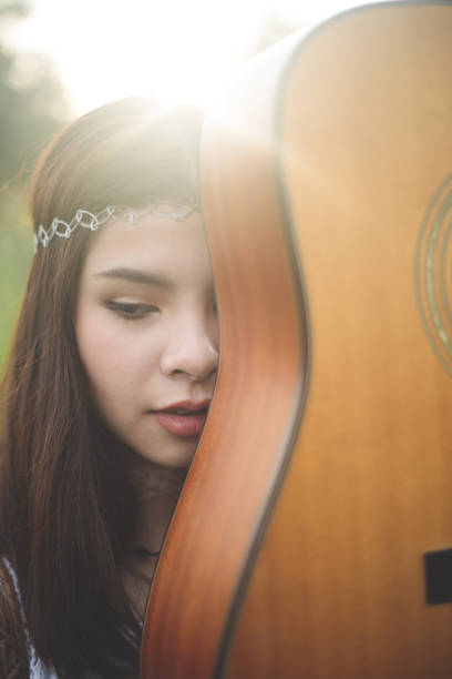 istock Young Asian Hipster playing guitar in the park 922771510