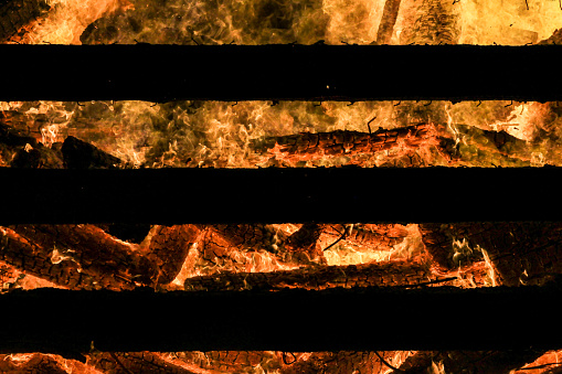 Logs in fire. Big huge traditional fire blaze glow. Background