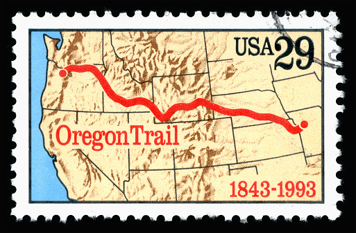 London, UK, February 19 2018 - Vintage 1993 United States of America 29c cancelled postage stamp showing an image of the anniversary of the Oregon Trail