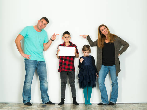 istock funny family on white wall, son with board 922774906