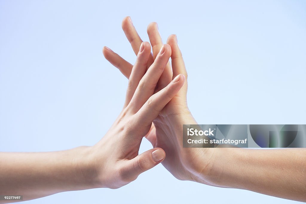 Two people holding hands together two hands are gently touching each other. Adult Stock Photo