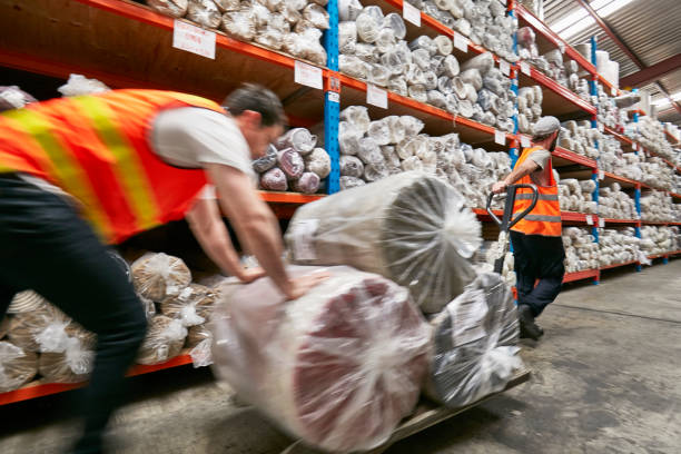 istock Workers moving carpets on pallet jack in factory 922777802