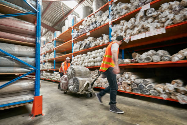 istock Workers moving rugs on pallet jack in factory 922777806