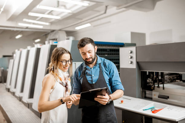 istock Woman with print operator at the printing manufacturing 922780398