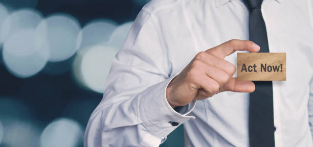 istock Man holding  wooden cube with Act Now! word. 922780516