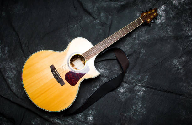 istock Acoustic guitar in a case on dark background 922784314