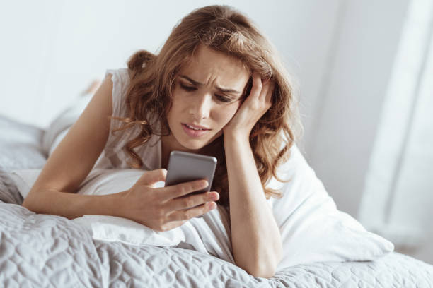 istock Emotionally exhausted woman grimacing while using her smartphone 922784612