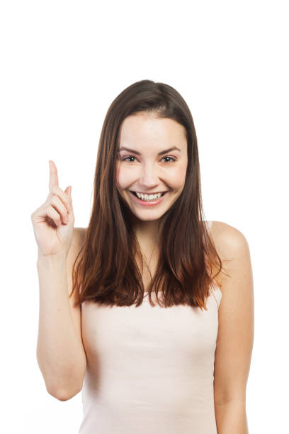 istock Very cute young woman pointing up 922785466