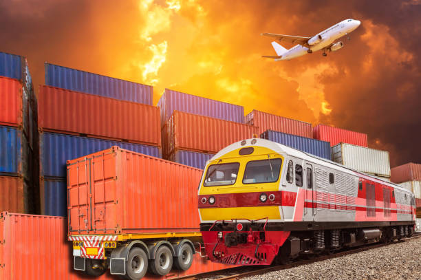 istock Global business with commercial cargo freight train and container cargo stack and trailer at the dock during cargo plane flying above on sunset 922785738