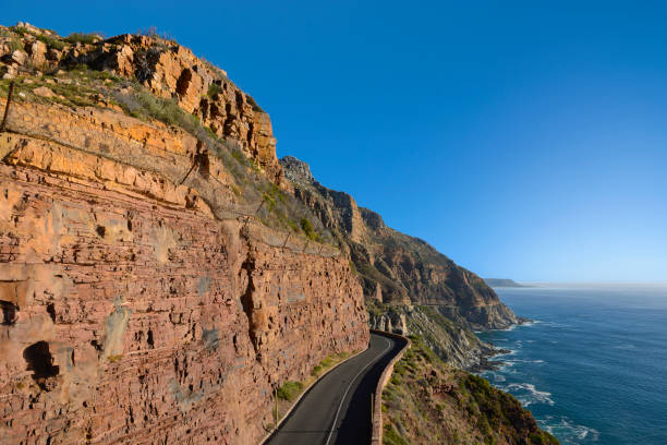 Chapman's Peak Drive The road at Chapman's Peak Drive. A scenic drive along the coast of the Cape Peninsula near Cape Town.  Leading from Houtbaai to Noordhoek. chapmans peak drive stock pictures, royalty-free photos & images