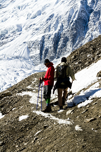 Annapurna Trek, Nepal - November 13, 2015: Tourists missing each other on the narrow path on the way to Tilicho lake (Tilicho Tal 4920 m), Himalayas, Manang district of Nepal.