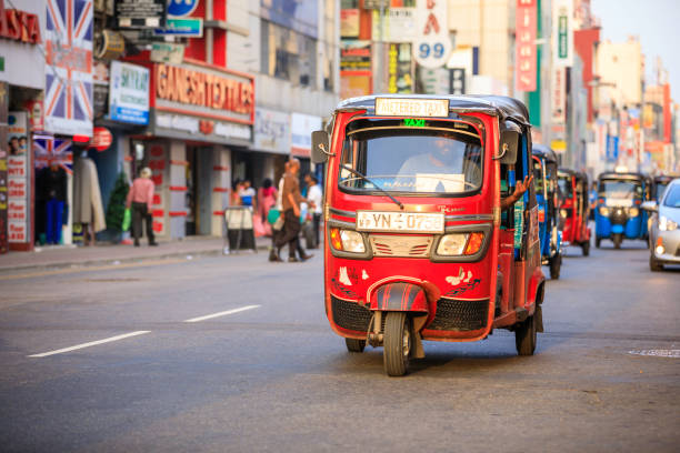 Tuktuk taxi on the streets of Colombo; Sri Lanka Colombo, Sri Lanka - December 7, 2016: Traffic and busy street in the center of Colombo, the capital city of Sri Lanka. Tuktuk taxi, the motorized development of the traditional pulled rickshaw, ride on a city street. taxi sri lanka stock pictures, royalty-free photos & images