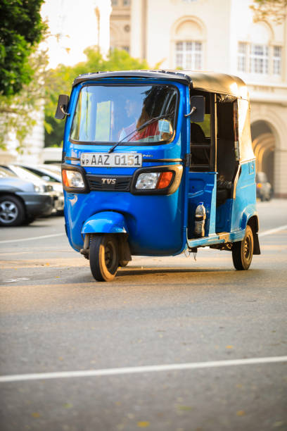 Tuktuk taxi on the streets of Colombo; Sri Lanka Colombo, Sri Lanka - December 7, 2016: Traffic and busy street in the center of Colombo, the capital city of Sri Lanka. Tuktuk taxi, the motorized development of the traditional pulled rickshaw, rides on a city street. taxi sri lanka stock pictures, royalty-free photos & images