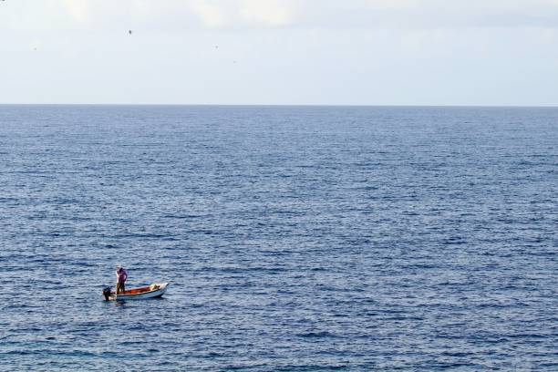 istock Man Boating On Sea Against Sky 922791600