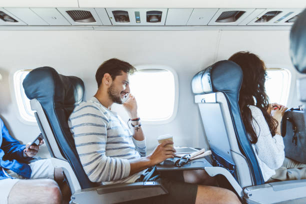 istock Male passenger talking on mobile phone during flight 922792404