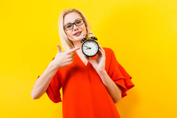 istock Blonde woman holding alarm clock 922794010