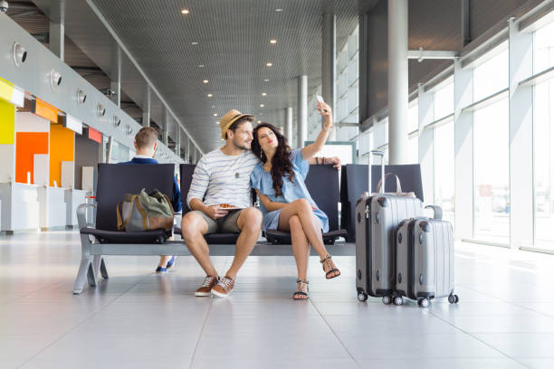 istock Young couple taking selfie in airport lounge 922796530