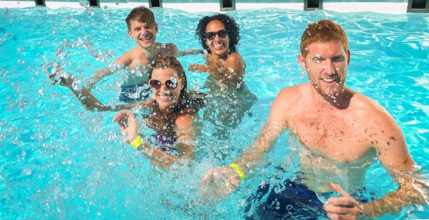 istock Two couple enjoying in swimming pool 922799050