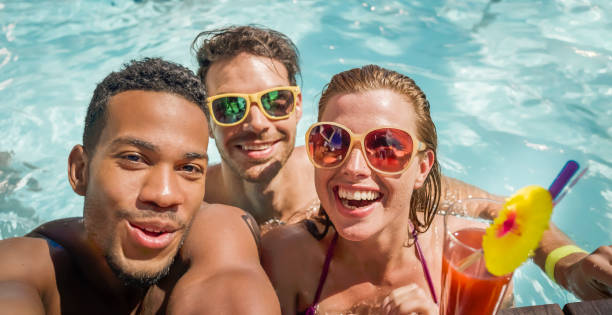 istock Friends enjoying in swimming pool 922799084