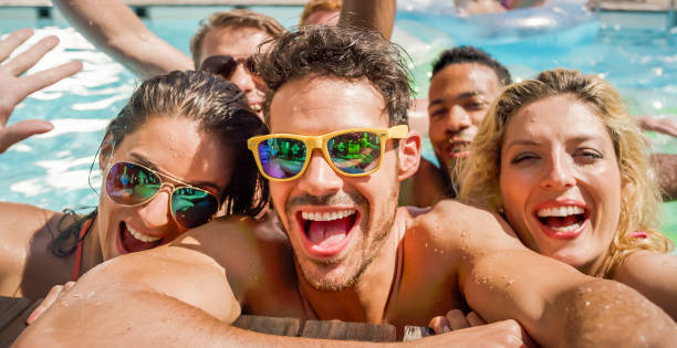 istock Friends enjoying in swimming pool 922799094
