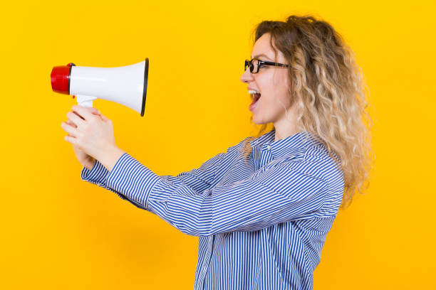 istock Woman in shirt with loudspeaker 922801334