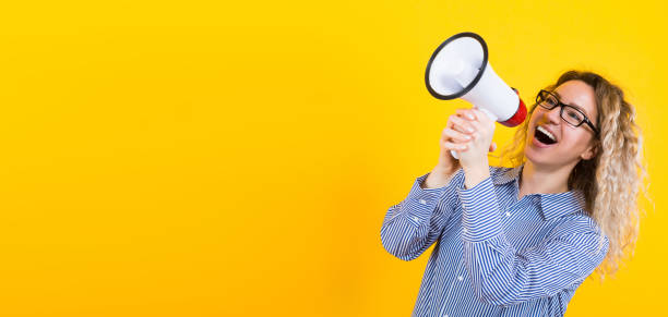 istock Woman in shirt with loudspeaker 922801350