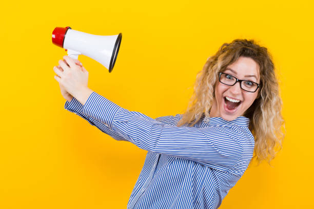 istock Woman in shirt with loudspeaker 922801362