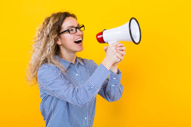 istock Woman in shirt with loudspeaker 922801378