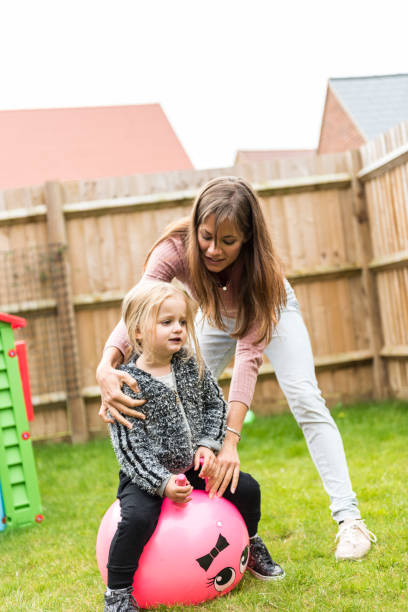 istock Mother having fun with daughter on the backyard 922801958