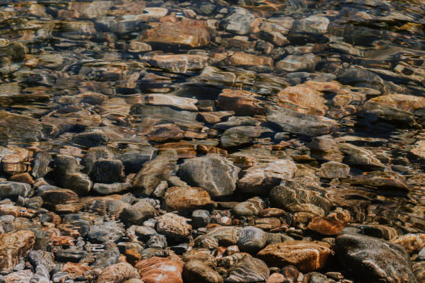 istock Stones, pebbles and sand on the shore of a mountain river 922802428