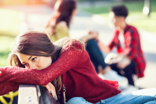 istock Sad woman turning back on the happy couple behind her 922802434